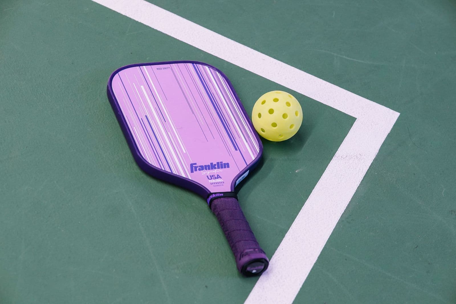 Pickleball paddle and ball on a Winnipeg court